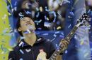 Kei Nishikori, of Japan, looks up at confetti as he is presented with a guitar trophy after defeating Kevin Anderson, of South Africa, in the championship match of the Memphis Open tennis tournament Sunday, Feb. 15, 2015, in Memphis, Tenn. Nishikori won 6-4, 6-4. (AP Photo/Mark Humphrey)