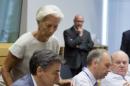 Managing Director of the International Monetary Fund Christine Lagarde, second left, prepares to speak with Greek Finance Minister Euclid Tsakalotos, second left, during a meeting of eurozone finance ministers at the EU Lex building in Brussels on Saturday, July 11, 2015. Greece's negotiators head to Brussels on Saturday armed with their reform proposals and parliamentary backing to seek a third bailout, but with the shadow of severe dissent from governing lawmakers hanging over them. (AP Photo/Virginia Mayo)