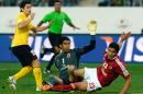 Guangzhou's midfielder Dario Conca (L) scores a goal past Al Ahly's goalkeeper Sherif Ekramy (C) and defender Mohamed Nagieb (R) during their FIFA Club World Cup quarter final football match in the Moroccan city of Agadir on December 14, 2013