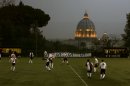 Players of Collegio San Paolo and North American Martyrs teams play their Clericus Cup soccer match, in Rome, Sunday, March 10, 2013. Vatican-supported soccer league matches went ahead as scheduled Sunday on a hill overlooking St. Peter's Basilica, shown in background. For the teams of seminaries, missionaries and oratories, however, the pre- and post-game talk centered on the coming conclave to elect a new pope. A coach of a Brazilian team was absent because he was chosen to drive two cardinals to Assisi for the day. "It didn't go so well today," Aldemir Fracisco Belever, the captain of the Collegio Pio Brasiliano seminary said after a 4-1 loss to Redemptoris Mater, a team featuring seminarians and priests with the Mater neocatechumenal movement. "It wasn't easy without our coach." (AP Photo/Alessandra Tarantino)