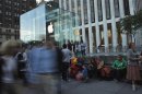 Customers wait in line outside the Apple store on 5th Avenue, for Friday's iPhone 5 models to go on sale, in New York