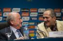FIFA President Sepp Blatter, left, talks with Brazil's Sports Minister Aldo Rebelo during a press conference where they talked about the organization and infrastructure of the upcoming World Cup, in Sao Paulo, Brazil, Thursday, June 5, 2014. The World Cup soccer tournament starts on 12 June. (AP Photo/Andre Penner)