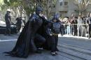 AP10ThingsToSee - Miles Scott, dressed as Batkid, right, walks with Batman before saving a damsel in distress in San Francisco, Friday, Nov. 15, 2013. San Francisco turned into Gotham City on Friday, as city officials helped fulfill Scott's wish to be "Batkid." Scott, a leukemia patient from Tulelake in far Northern California, was called into service on Friday morning by San Francisco Police Chief Greg Suhr to help fight crime, The Greater Bay Area Make-A-Wish Foundation says. (AP Photo/Jeff Chiu)