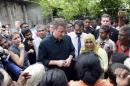 Britain's Prime Minister Cameron talks with Tamil people at the Sabapathi Pillay Welfare Centre in Jaffna