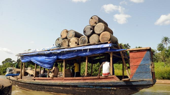 Products of illegal oil refineries in jerry cans are ferried to the market in Bayelsa State on the Niger Delta on April 11, 2013