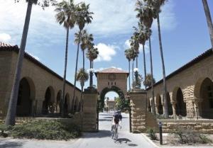 A cyclist exits the entryway to the Main Quad at Stanford&nbsp;&hellip;