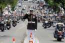 A Marine salutes as motorcycles drive past during the annual Rolling Thunder parade ahead of Memorial Day in Washington, Sunday, May 27, 2012. (AP Photo/Charles Dharapak)