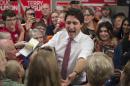 FILE - In a Saturday, Oct. 17, 2015 file photo, Liberal leader Justin Trudeau greets supporters as he makes his way through a crowd at a campaign rally in Winnipeg, Manitoba, Canada. Trudeau, the son of late Prime Minister Pierre Trudeau, is leading in the polls ahead of Monday's election that could spell the end of a decade of Conservative rule under Stephen Harper. (Paul Chiasson/The Canadian Press via AP, File)