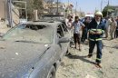 Iraqis gather at the site of a car bomb in Al-Nasr neighbourhood in the northern Iraqi town of Kirkuk, September 5, 2013