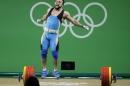 Nijat Rahimov, of Kazakhstan, celebrates after setting a world record with a lift of 214kg in the clean and jerk during the men's 77kg weightlifting competition at the 2016 Summer Olympics in Rio de Janeiro, Brazil, Wednesday, Aug. 10, 2016. (AP Photo/Mike Groll)
