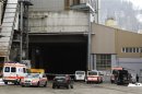 Police and rescue service vehicles are seen in front of the wood processing plant of Kronospan following a shooting in Menznau near Lucerne