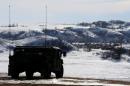 A North Dakota National Guard vehicle idles on the outskirts of the Dakota Access oil pipeline protest camp near Cannon Ball