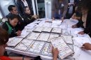Election officials and party representatives recount votes at an electoral institute district council in Mexico City, Thursday, July 5, 2012. Of the 143,000 ballot boxes used during last Sunday's general elections, 78,012, or more than half of the total, will be opened and the votes recounted, according to Mexican electoral officials. (AP Photo/Marco Ugarte)
