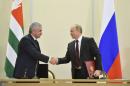 Russian President Vladimir Putin shakes hands with Abkhazia's President Raul Khadzhimba during a signing ceremony at the Bocharov Ruchei state residence in Sochi
