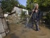 A local resident stands at a flooded house in Krimsk, about 1,200 kilometers (750 miles) south of Moscow, Russia, Sunday, July 8, 2012. The death toll from severe flooding in the Black Sea region of southern Russia has risen to at least 150. (AP Photo/Ignat Kozlov)