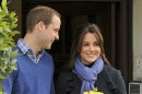 Britain's Prince William stands next to his wife Kate, Duchess of Cambridge as she leaves the King Edward VII hospital in central London, Thursday, Dec. 6, 2012. Prince William and his wife Kate are expecting their first child, and the Duchess of Cambridge has been admitted to hospital suffering from a severe form of morning sickness in the early stages of her pregnancy. (AP Photo/Andrew Matthews, PA)