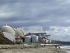 File photo of a man walking his dog next to damaged San Onofre power plant located next to San Onofre State Park in California