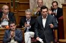 Greek Prime Minister Alexis Tsipras (R) addresses a parliamentary session in Athens on July 15, 2015
