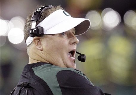 Oregon football coach Chip Kelly yawns as he looks at the scoreboard during the second half of their NCAA college football game against Arizona in Eugene, Ore., Saturday, Sept. 22, 2012.   Oregon won 49-0.(AP Photo/Don Ryan)