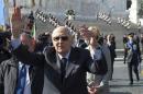 Italy's President Napolitano waves during a Liberation Day ceremony at the Unknown Soldier's monument in central Rome