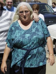 Sharon Jones, center, who cashed a winning lottery ticket after taking it from a bin of discarded tickets July 15, 2011, at a Beebe, Ark., convenience store, walks to a court house during a break in a trial in Searcy, Ark., Tuesday, May 1, 2012. (AP Photo/Danny Johnston)