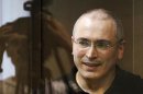Jailed Russian ex-tycoon Khodorkovsky stands in the defendant's box during a court session in Moscow