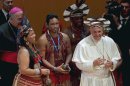Pope Francis wears an indigenous headdress given to him by Ubirai Matos from the Pataxo tribe, fourth from left, after the pontiff spoke at Rio's Municipal Theater to an audience mostly made up of Brazil's political, business and cultural elite in Rio de Janeiro, Brazil, Saturday, July 27, 2013. Pope Francis is on the sixth day of his trip to Brazil where he will attend the 2013 World Youth Day in Rio. (AP Photo/Monica Imbuzeiro, Agencia O Globo)