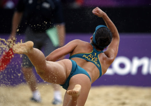 Australia's Becchara Palmer dives to save a shot during their women's beach volleyball preliminary round match against Germany at the London 2012 Olympics Games at the Horses Guards Parade