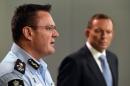 Australian Federal Police deputy commissioner Michael Phelan (L) speaks to the media as Prime Minister Tony Abbott listens, in Sydney, on April 18, 2015