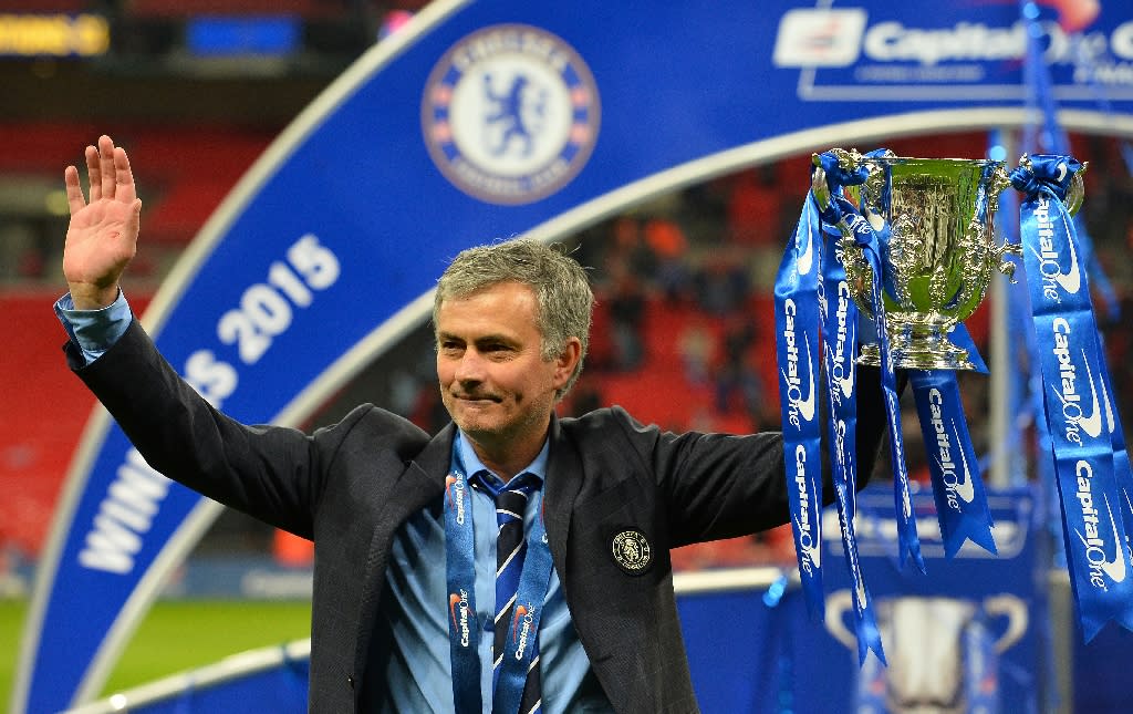 Chelsea's Portuguese manager Jose Mourinho celebrates with the trophy during the presentation after Chelsea won the League Cup final football match against Tottenham Hotspur at Wembley Stadium in London on March 1, 2015