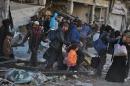 Syrian civilians are evacuated during a humanitarian operation in the besieged city of Homs on February 10, 2014