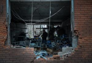 A man stands inside a building damaged by shelling &hellip;