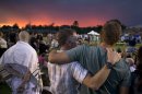 The sun sets as mourners gather for a candlelight vigil in Prescott, Ariz. Tuesday, July 2, 2013 to honor the 19 Granite Mountain Hotshot firefighters who were killed by an out-of-control blaze near Yarnell, Ariz. on Sunday. (AP Photo/Julie Jacobson)