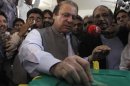Nawaz Sharif, leader of the Pakistan Muslim League - Nawaz (PML-N) political party, casts his vote for the general election at a polling station in Lahore
