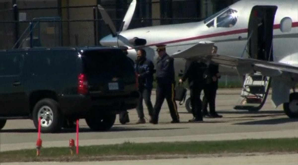 Canadian police escort suspect Chiheb Esseghaier from a plane to a