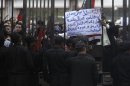 Egyptians shout slogans against Egyptian President Mursi and members of Brotherhood in front of High Judicial Court during an emergency meeting held by Egyptian judges in downtown Cairo