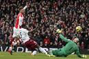Arsenal's French striker Olivier Giroud (L) lifts the ball over Aston Villa's American goalkeeper Brad Guzan to score the opening goal during the Premier League clash at the Emirates Stadium in London on February 1, 2015
