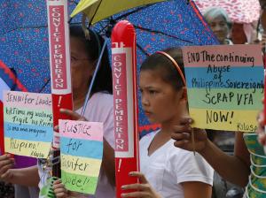 Protesters display placards during a rally near the &hellip;
