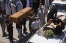 Mourners carry coffins of victims killed by suicide bomber attack inside Shi'ite mosque in Baghdad, during a funeral in Najaf