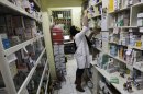In this Tuesday, Dec. 11, 2012 photo, an Iranian pharmacist arranges medicine on shelves at a pharmacy in central Tehran, Iran. While medicine and humanitarian supplies are not blocked by the economic embargoes on Iran over its nuclear program, the pressures are clearly evident in nearly every level of Iranian health care. It's a sign of the domino effect of sanctions on everyday life. (AP Photo/Vahid Salemi)