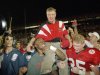 FILE - In this Jan. 1, 1995 file photo, Nebraska players carry coach Tom Osborne off the field after the Huskers defeated Miami 24-17 in the Orange Bowl NCAA college football game in Miami. Osborne will retire as Nebraska's athletic director on Jan. 1, 2013, and end an association with the university that began in 1962. (AP Photo/Doug Mills, File)