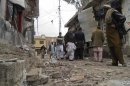 Residents gather at the site of a suicide bomb attack in the northwestern town of Hangu