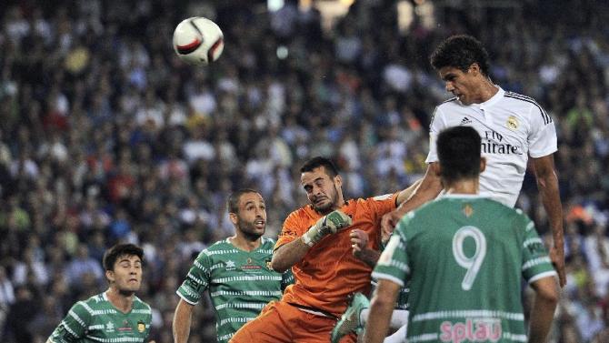 Real Madrid&#39;s French defender Raphael Varane (R) scores a goal against UD Cornella, at the Power8 stadium near Barcelona, on October 29, 2014