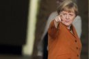 German Chancellor Merkel gestures as she welcomes European Commission President Manuel Barroso for talks at Chancellery in Berlin