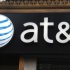 FILE-This May 6, 2012, file photo, shows an AT&T sign at a store in New York. Following in Verizon's footsteps, AT&T said Wednesday, July 18, 2012, it will introduce wireless plans that let subscribers connect up to ten devices. Connected phones get unlimited calling and texting, and all devices get wireless data access. The devices tap into a limited pool of data usage, which get renewed each month.  (AP Photo/CX Matiash, File)