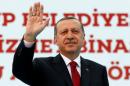 Turkish President Erdogan greets his supporters during an opening ceremony in Istanbul