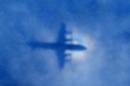 This shadow of a Royal New Zealand Air Force P3 Orion aircraft is seen on low cloud cover while it searches for missing Malaysia Airlines flight MH370, over the Indian Ocean on March 31, 2014