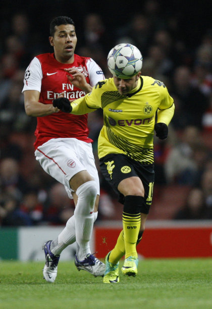 Arsenal's Andre Santos, left, watches as Borussia Dortmund's Mario Gotze heads the ball during their Champions League group F soccer match at the Emirates stadium, London, Wednesday Nov. 23, 2011. (AP Photo/Kirsty Wigglesworth)