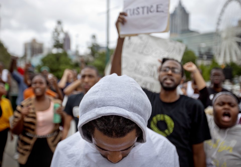 A demonstrator wears a hoodie during a protest the day after George Zimmerman was found not guilty in the 2012 shooting death of teenager Trayvon Martin, Sunday, July 14, 2013, in Atlanta. (AP Photo/David Goldman)