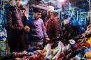 Iraqi men visit the great bazaar of Al-Zahraa in eastern Mosul on January 11, 2017, as the military operation against the Islamic State group continues